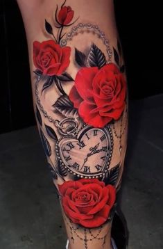 a woman's leg with red roses and an old clock tattoo on her calf