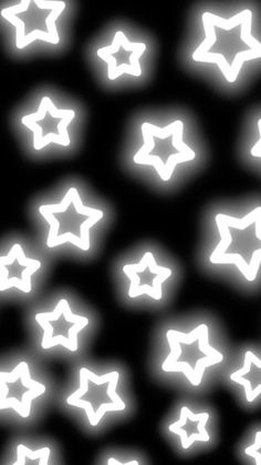 many white stars on a black background with some light coming from the top and bottom