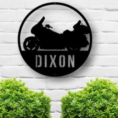 a black and white sign that says dixon on the side of a brick wall