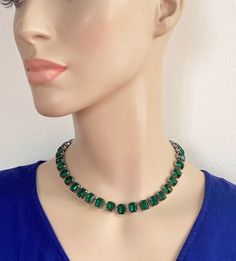 Choker length emerald paste riviere necklace.  Large rectangular faceted stones with closed back settings.  Vibrant deep green crystals. Bright silver tone metal. Hinged clip.  Circa 1970s.  Condition: Excellent for vintage.  Clasp works well.  Minor signs of age and use can be expected. Ready to wear or gift.  Weight: 47.1g Presentation:  Smart gift pouch, suitable for any occasion.  Please note that any boxes you see in photos are usually just for display purposes.  To ensure there's no confus Green Crystal Rhinestone Necklace For Formal Occasions, Green Rhinestone Necklaces For Formal Occasions, Formal Green Rhinestone Necklaces, Formal Green Rhinestone Jewelry, Green Rhinestone Necklace For Formal Occasions, Formal Green Rhinestone Necklace, Riviere Necklace, Smart Gift, Gift Pouch