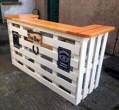 an outdoor bar made out of pallets and wooden planks with the words the bar on it