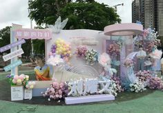 an outdoor display with balloons and flowers