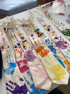 several handprints are on the table and one is tied to a bag with string