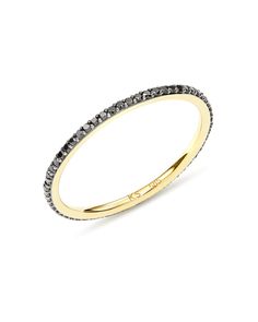 a yellow gold ring with black diamonds