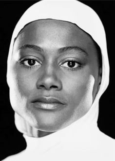 a black and white photo of a woman wearing a headscarf