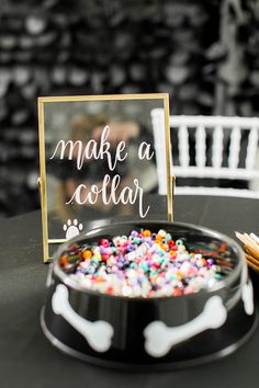 a black table with a sign that says make a collar and dog paw prints on it