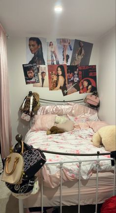 there is a bed with pictures on the wall above it