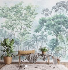 a living room with a large wall mural and potted plants