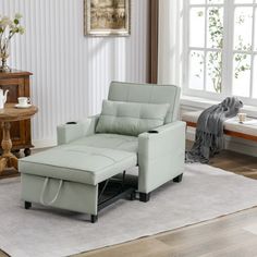 a light green recliner sitting on top of a white rug in a living room