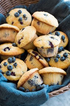 a basket filled with blueberry muffins on top of a table