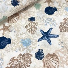 the fabric has shells and starfishs on it