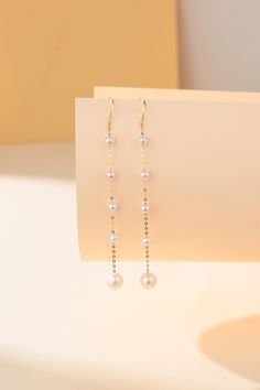 Enhance your jewelry collection with our Freshwater Pearl Dangle Cluster Earrings, featuring elegant 18K gold hooks. Each earring is intricately designed with four small pearls linked by fine gold wires, culminating in a luminous 6-7mm pearl at the bottom. The combination of delicate pearls and the luxurious warmth of 18K gold creates a stunning visual harmony, perfect for adding a touch of sophistication to any ensemble. Product Details: Pearl Type: Freshwater Pearls Pearl Size: Small pearls wi Gold Hooks, Pearl Design, Pearl Types, Pearl Earrings Dangle, Cluster Earrings, Gold Wire, Pearl Size, Buying Jewelry, Earrings Jewelry