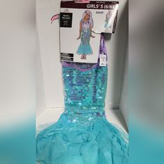 a mermaid costume is displayed in a box