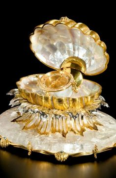 an ornate gold and white shell shaped dish