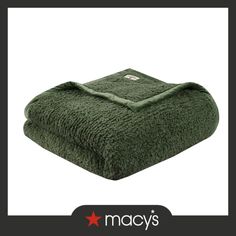 a green blanket with the words macy's on it