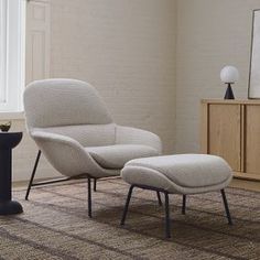 an egg chair and ottoman in a living room