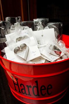 a red bucket filled with lots of cards