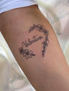 a woman's arm with a tattoo that reads, valentinea and flowers on it