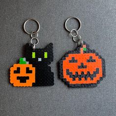 two pieces of lego key chains with pumpkins on them