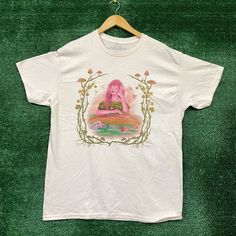 a white t - shirt with an image of a woman on it