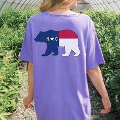 Celebrate North Carolina's wild side with our shirt featuring the state flag in the shape of a bear, symbolizing strength and natural beauty. This unique design honors the Tar Heel State's rich wildlife and heritage, making it perfect for outdoor enthusiasts and proud residents. Wear it proudly and showcase your love for North Carolina's untamed spirit. * 100% ring-spun cotton * Relaxed fit * Unisex Casual Bear Design Short Sleeve T-shirt, Graphic Tee With Bear Design, Short Sleeve Graphic Tee With Bear Design, Graphic Tee With Bear Design, Short Sleeve, Bear Design Graphic Tee Short Sleeve T-shirt, Bear Design Graphic Tee With Short Sleeves, Casual Short Sleeve Tops With Bear Design, North Carolina Shirt, North Carolina Gifts