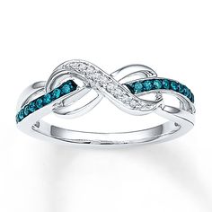 An infinity symbol embraces a band of sterling silver decorated in blue diamonds in this stylish ring for her. Round white diamonds complete the look. The ring has a total diamond weight of 1/8 carat. Blue diamonds are treated to permanently create the intense blue color. Tattoos Infinity, Spinel Jewelry, Nature Inspired Engagement Ring, Gold Flower Ring, Tattoos Skull, Vintage Gold Rings, Blue Diamonds, Jewelry Advice, Stylish Rings