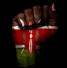 a person's hand painted with the flag of kenya and crossed sabers on it