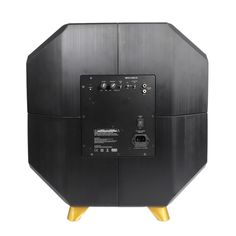 the back side of a black speaker with gold legs