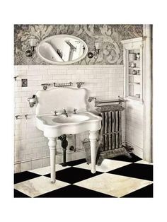 an old fashioned bathroom with black and white checkered flooring, pedestal sink and mirror