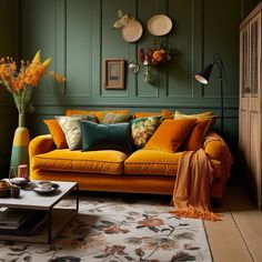 a living room with green walls and yellow couches in the center, surrounded by orange flowers