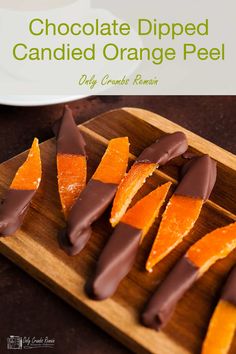 chocolate dipped candied orange peels on a wooden cutting board with text overlay