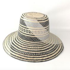 Handwoven Silver, Brown And Natural Straw Hat With A Wide Brim And Interior Band. Each Of Our Artisan Hats Is Unique And Takes Approximately 8-10 Hours To Hand Weave By Skilled Artisans In The Guajira Desert Of Colombia. Pair With One Of Our Handwoven Pom-Pom Hat Bands For A Fun Pop Of Color. Pom Pom Hat Bands Are Available In A Variety Of Colors And Are Sold Separately. Comment Below If You're Interested In Purchasing A Pom Pom Hat Band And We Will Let You Know What Colors We Have Available. Br Traditional Woven Straw Hat For Spring, Artisan Black Hat For Summer, Traditional Short Brim Fedora For Beach, Traditional Black Summer Hats, Artisan Woven Fedora Sun Hat, Black Handwoven Short Brim Hat, Black Handwoven Brimmed Hat, Black Handwoven Straw Hat With Curved Brim, Multicolor Woven Panama Hat With Short Brim