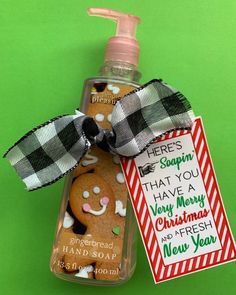 a bottle of hand soap with a gingerbread christmas cookie on it and a ribbon