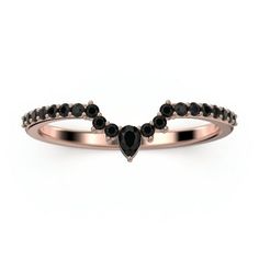 a rose gold ring with black diamonds on the sides and an arrow shaped band in the middle