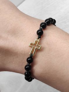 Adjustable women's bracelet featuring natural black onyx 6 mm beads, stainless steel gold filled 14k cross, protection bracelet, gift idea. To order right size just measure your wrist and select the length from the dropdown menu. The option Size of wrist 15,5cm/6inch fits for wrist 15,5 and more. Option 18cm /7inches will have more beads and fits for 18cm wrist and bigger. We can customize this to any length, please just contact me. Handmade in Greece Made with love ❤️ and carefully manufactured Black Rosary Bracelet With Gemstone Beads As Gift, Black Gemstone Beads Rosary Bracelet Gift, Adjustable Black Rosary Bracelet With Gemstone Beads, Adjustable Black Beaded Rosary Bracelet, Black Beaded Rosary Bracelet As Gift, Black Rosary Bracelet As A Gift, Black Hand-strung Rosary Bracelet As Gift, Black Hematite Crystal Bracelet For Spiritual Use, Black Hematite Crystal Bracelet Spiritual