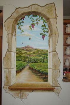 a painting on the side of a wall with a window and view of vineyards