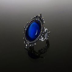 This ornate ring features a Sapphire blue cabochon set in a beautifully decorative mount (measuring 35 x 25 mm) on a stunning filigree band. The Sterling silver plated filigree ring is adjustable so one size fits all. The deep Sapphire blue cabochon shimmers beautifully when it catches the light. Nickel and lead free. This Sapphire blue filigree ring compliments perfectly our Sinistra lace choker which can be found in our Etsy store. The full Sinistra range of venise lace chokers and matching ri