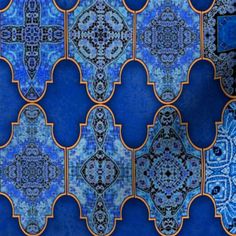 an image of blue and gold wallpaper with intricate designs on it's surface