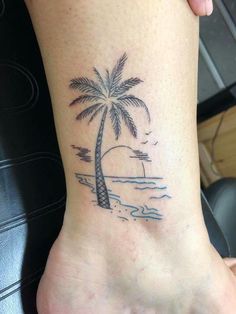 a small palm tree tattoo on the ankle