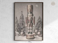 a wooden nutcracker standing in front of christmas trees