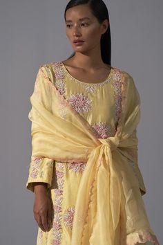 Yellow silk kurta featuring zardozi embroidery embellished with floral applique and sequin work. Comes with matching pant and scalloped edge dupatta.
Components: 3
Pattern: Embroidered
Type Of Work: Zardozi
Neckline: Round
Sleeve Type: Full
Fabric: Silk
Color: Yellow
Other Details: 
Length:
Kurta: 38-39 Inches 
Pant: 40 Inches
Occasion: Sangeet,Mehendi and Haldi - Aza Fashions Raw Silk Palazzo Set With Zari Work, Cotton Silk Sets With Gota Work For Reception, Silk Embroidered Palazzo Set For Reception, Embroidered Silk Palazzo Set For Reception, Silk Kurta With Dori Work For Reception, Reception Slub Silk Palazzo Set, Chikankari Embroidery Raw Silk Palazzo Set, Embroidered Tissue Silk Palazzo Set For Reception, Silk Unstitched Suit With Gota Work