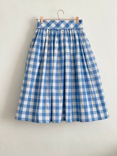 "Denim Blue check high waist full gathered skirt. Perfect for casual outfits and special ocasions with pair of trainters or high heels. 100% cotton.  Elastic at the back of waist.  Two side pockets. Midi lenght about 70cm + 5 cm waistband. Handmade in UK.  Model wears size S.  HOW TO CHOOSE A SIZE ?   Using a measuring tape, measure the smallest part of your waist.  SIZE CHART: (CM) XS - W: 66 CM S - W: 70 CM M - W: 74 CM  L - W: 78 CM  XL - W: 82 CM  CARE INSTRUCTIONS: Hand wash only, do not bleach, hang dry, do not tumble dry, press with a cool iron on the reverse side.  Please message me before purchasing so I can check availability. If you wish this skirt in any other fabric, shorter or longer \"send message to seller\" and we can try to make something especially for you. *Depends on c Fitted Cotton Skirt For Picnic, Plaid Cotton Lined Skirt Bottoms, Plaid Cotton Relaxed Skirt, Casual Gingham Cotton Skirt, Spring Gingham Cotton Skirt, Plaid Cotton Long Skirt, Plaid Long Cotton Skirt, Long Plaid Cotton Skirt, Gingham Gathered Skirt Bottoms For Spring