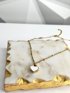 Our Double-sided Heart Necklace, made from 18k gold-plated stainless steel, is sure to make a bold and stylish statement. The timeless color combination of white and black is perfect for any occasion, whether you’re dressing up or down. Wear it with your favorite outfit and let your heart shine! 💖 Features: 18k Gold Plated High-Quality Stainless Steel Tarnish Free White Heart-shaped Minimalist Jewelry, Minimalist White Heart-shaped Jewelry, White Heart Pendant Necklace As Gift For Her, White Heart Charm Jewelry For Everyday, White Minimalist Jewelry With Heart Charm, Minimalist White Heart Charm Jewelry, Minimalist White Necklace For Valentine's Day, Dainty White Heart Necklace With Delicate Chain, Minimalist White Heart Necklace For Everyday