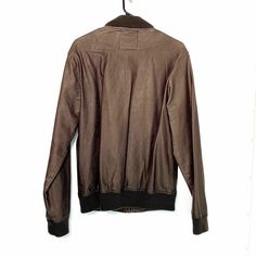 Stay stylish with this Five Four Men’s Faux Leather Bomber Jacket in size M (38-40). Featuring a sleek brown polyurethane exterior and a soft polyester lining, this jacket is perfect for casual wear. With a chest measurement of 42 inches and a length of 28 inches, it offers a comfortable fit. In Excellent Used Condition (EUC), this jacket includes ribbed cuffs and hem, giving it a classic bomber style while providing extra warmth and a snug fit. The full zip closure and side pockets add function Brown Outerwear With Zip Fly For Work, Brown Leather Jacket For Streetwear, Brown Long Sleeve Leather Jacket For Streetwear, Brown Leather Jacket With Zipper Closure, Vintage Brown Outerwear For Winter Streetwear, Casual Brown Leather Jacket With Long Sleeves, Brown Fitted Masculine Leather Jacket, Masculine Fitted Brown Leather Jacket, Casual Brown Leather Jacket With Zipper