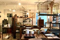 a room filled with lots of different types of dishes and pans on top of wooden tables