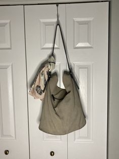 "Gorgeous mushroom/taupe supple suede shoulder bag with leather base and strap for durability. Convenient exterior zip pocket, snap top closure, strap adjustable with buckles.   15\" high without strap, 26\" high with strap. 13\" wide, and 6.5\" deep.  Some light soiling, age related, no rips tears or interior issues. (Scarf not included, for display purposes only.)  Check the photos for condition, and please keep in mind that vintage items are not new items. They are gently used and may show some signs of wear due to being loved and utilized over the years. Any major flaws or defects will always be noted in the description and documented in photos of the item."