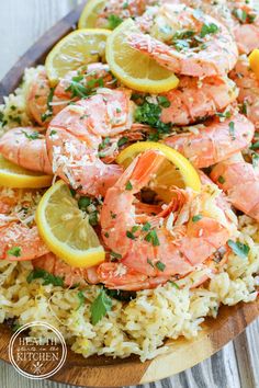 shrimp and rice with lemon wedges on a wooden platter, ready to be served