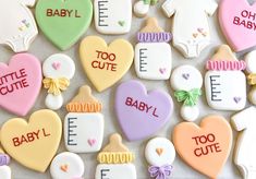 baby shower cookies are arranged in the shape of hearts