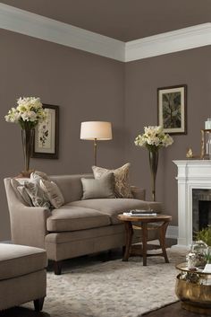 a living room filled with furniture and a fire place in front of a white fireplace