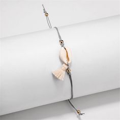 Boost your shine appeal with this gleaming anklet ready to add a splash of unexpected shine to your look. Chain: 7.87'' L with 3.15'' extender Shell: 1.38'' W x 0.79'' L Adjustable Sliding bead closure 18k gold-plated copper / shell / polyester Tassel Anklet, Beading Thread, Women Chain, Fashion Boho, Bracelet Women, Anklet Bracelet, Beach Jewelry, Womens Bracelets, Jewelry Gift